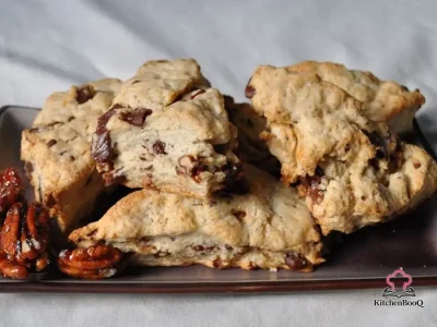 Freshly baked 5-spice scones with chunks of semi-sweet chocolate and spiced pecans on a wire cooling rack