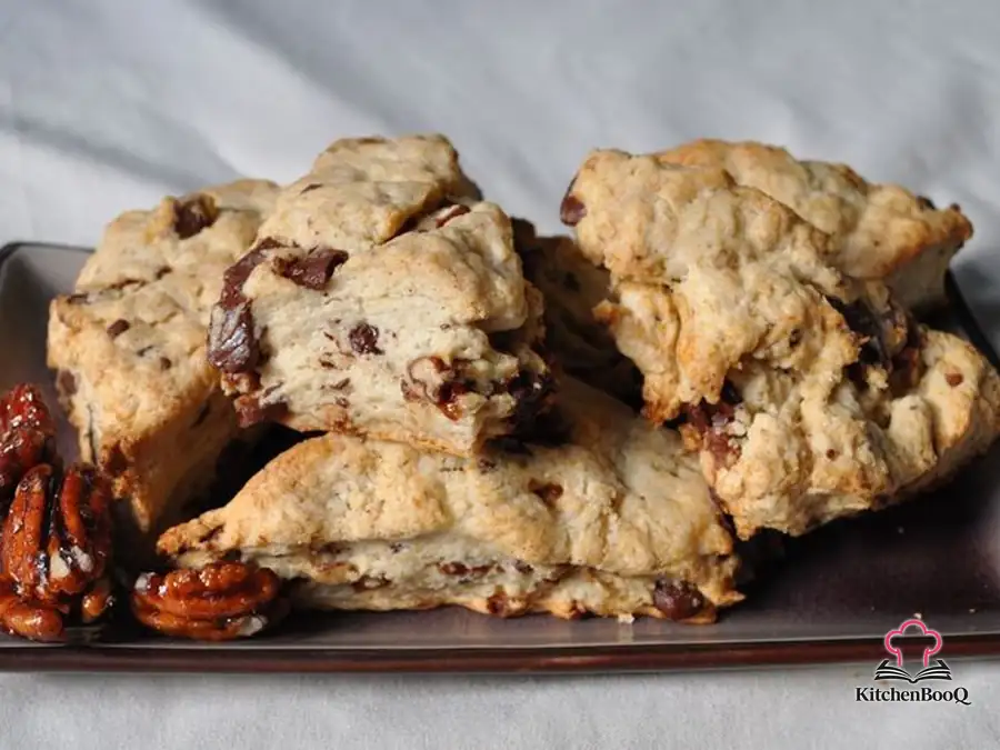 Freshly baked 5-spice scones with chunks of semi-sweet chocolate and spiced pecans on a wire cooling rack