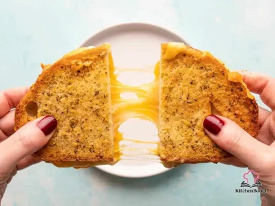 Golden crispy air fryer grilled cheese sandwich made with sourdough bread and Parmesan herb butter, sliced in half to reveal melted gooey cheese pull