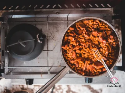 A bowl of saucy BBQ beans with ground beef garnished and served from an Instant Pot