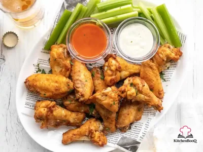 Golden crispy baked chicken wings seasoned with smoked paprika and spices on a wire rack lined baking sheet