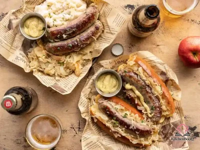 Five bratwurst links nestled in golden sauerkraut with sliced apples and onions in a large skillet