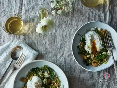 A white Dutch oven filled with vibrant green herb rice, white beans, peas, crumbled goat cheese, and fresh mint leaves, topped with a poached egg
