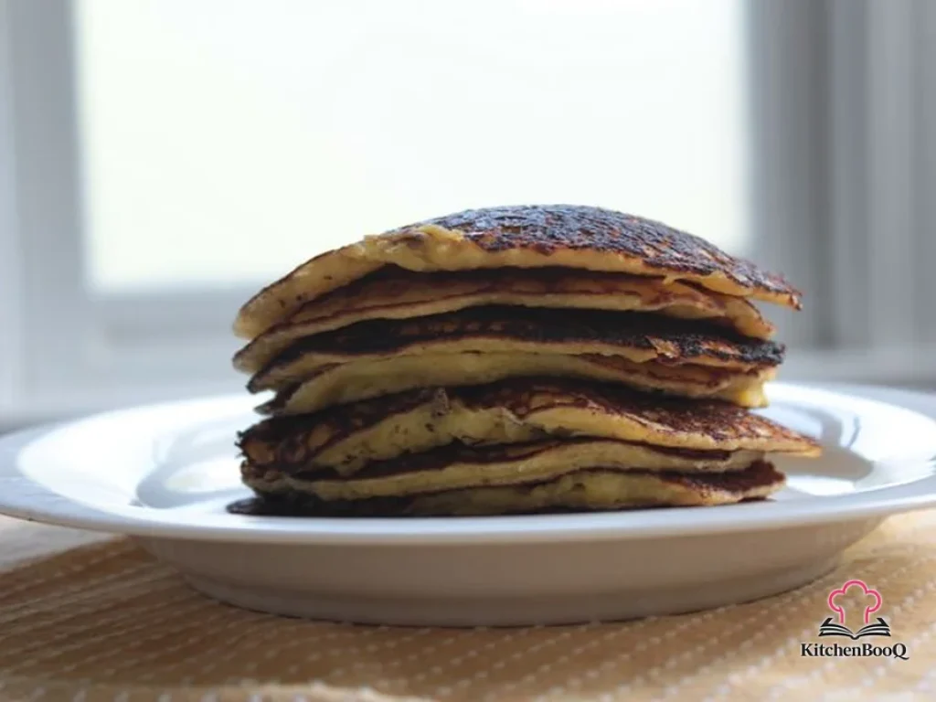 Golden Venezuelan cachapas fresh corn pancakes stacked on a plate topped with crumbled Cotija cheese