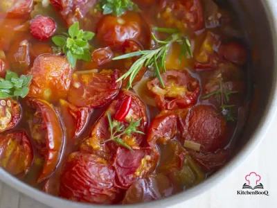 A bowl of cannellini bean stew with pancetta, whole plum tomatoes, and a drizzle of extra-virgin olive oil, served in a rustic ceramic bowl