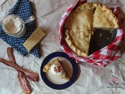 Slice of cheddar crusted maple apple pie with golden flaky pastry and tender spiced apple filling on a rustic wooden board