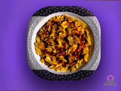 Chili-pasta skillet with ground beef, kidney beans, elbow macaroni, and melted cheddar cheese in a large skillet